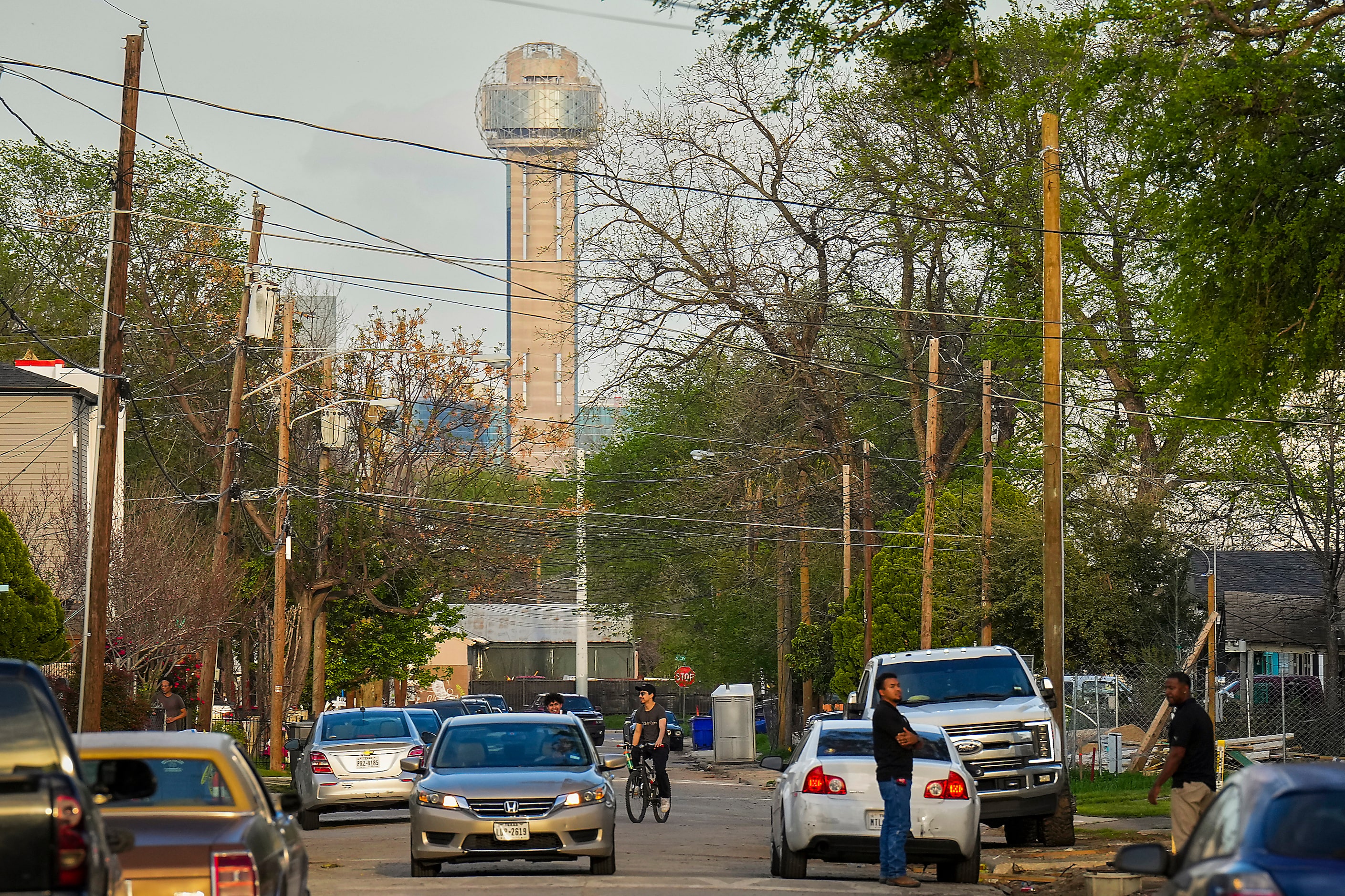 Reunion Tower looms over activity on Muncie Avenue in the Gilbert-Emory neighborhood  on...