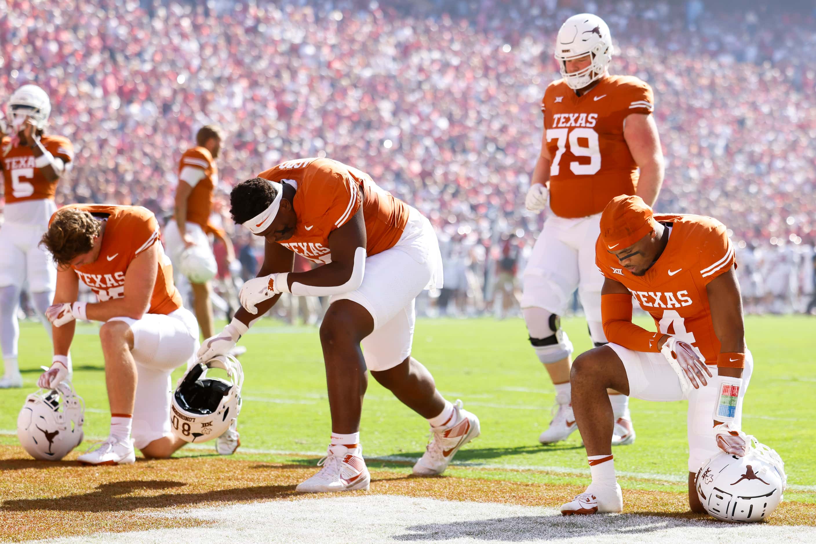 Texas players gather to pray ahead of the Red River Rivalry at the Cotton Bowl, on Saturday,...