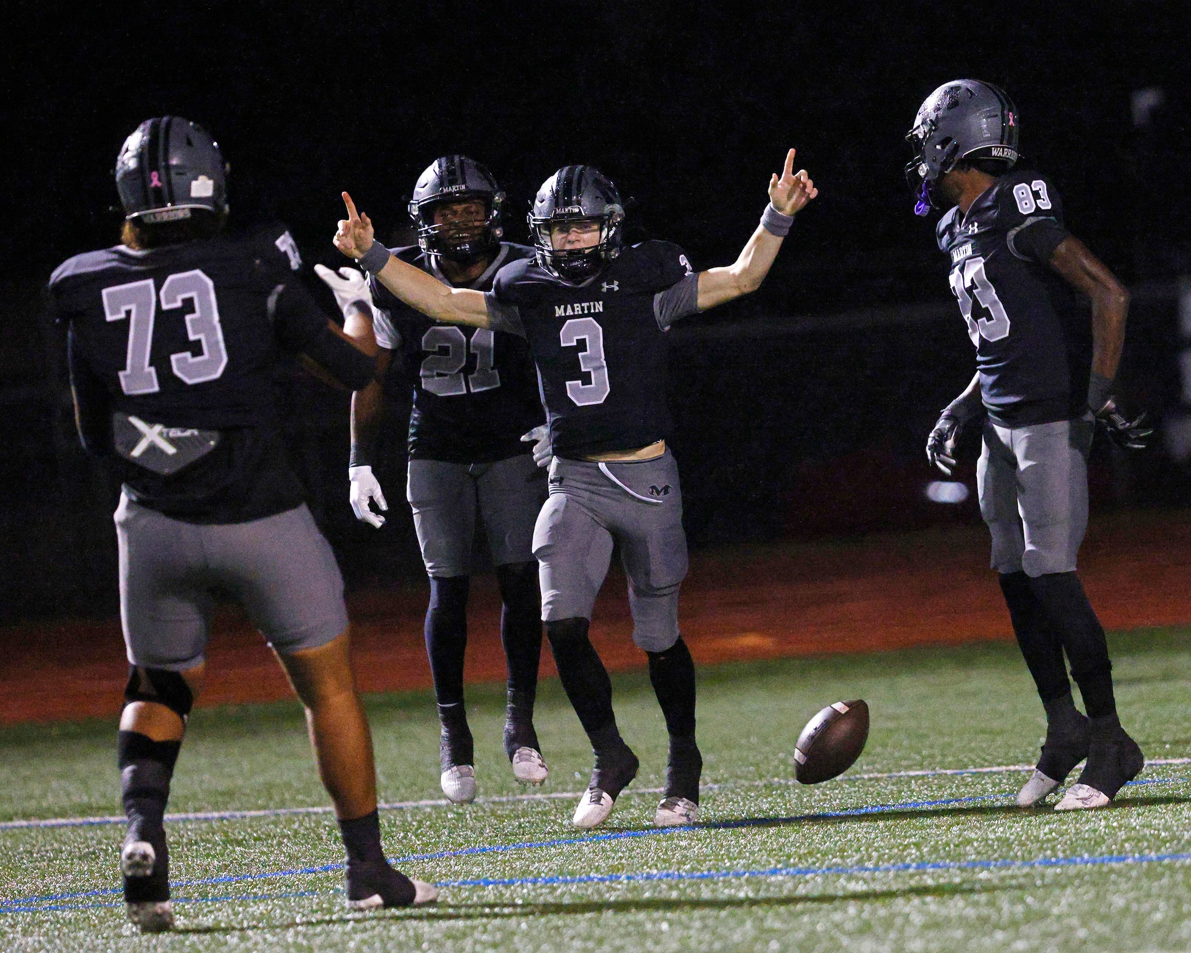 Martin's Brooks Brigand (3) celebrates his touchdown with his teammates Makai Saina (73),...