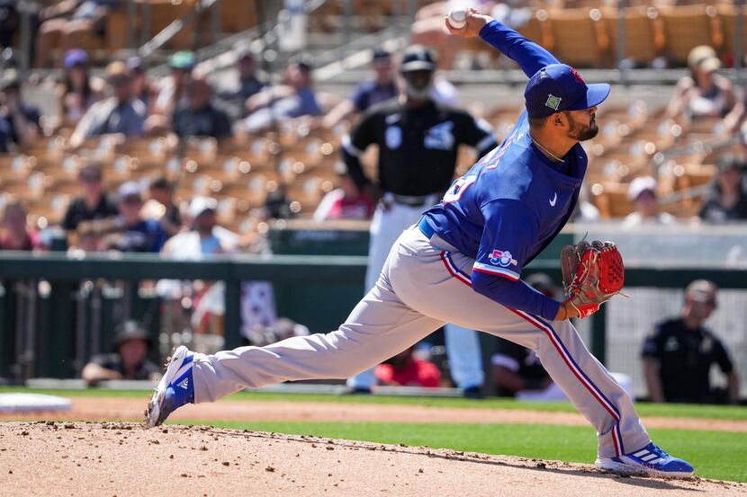 Texas Rangers pitcher Martín Pérez delivers during the first inning of a spring training...