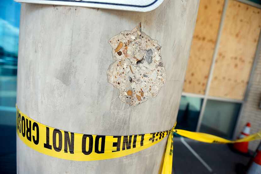 
Damage from a bullet is seen in a concrete column outside the Dallas Police Department's...