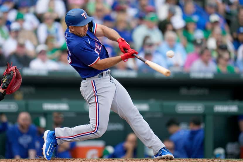 Texas Rangers' Wyatt Langford connects for a run-scoring single against the Chicago Cubs...