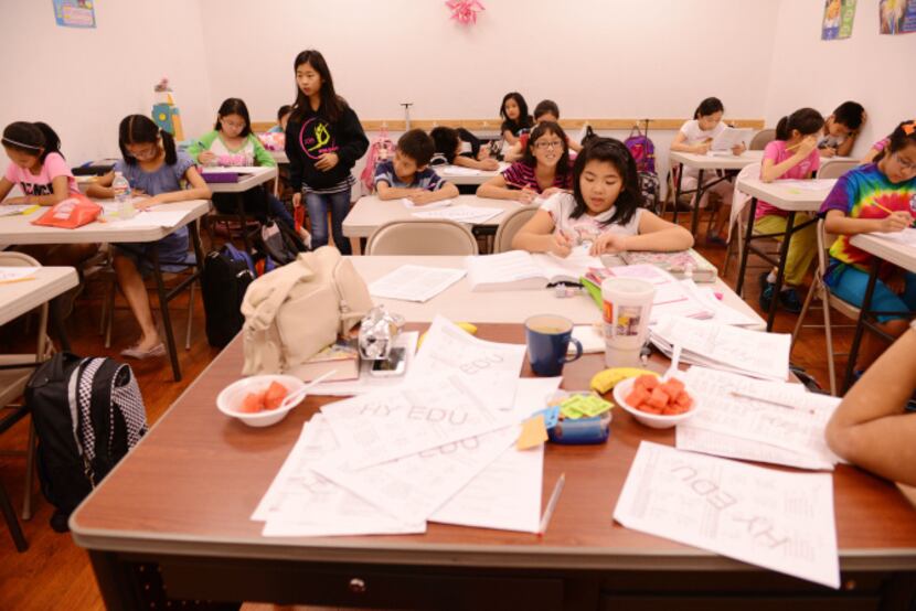 Students do school work at HuaYi Education, a Chinese school offering supplemental education...