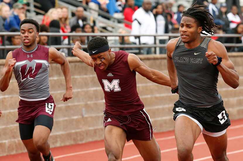 Tyler Owens (right) of Plano East wins the Class 6A 100 meters at the Jesuit-Sheaner Relays...