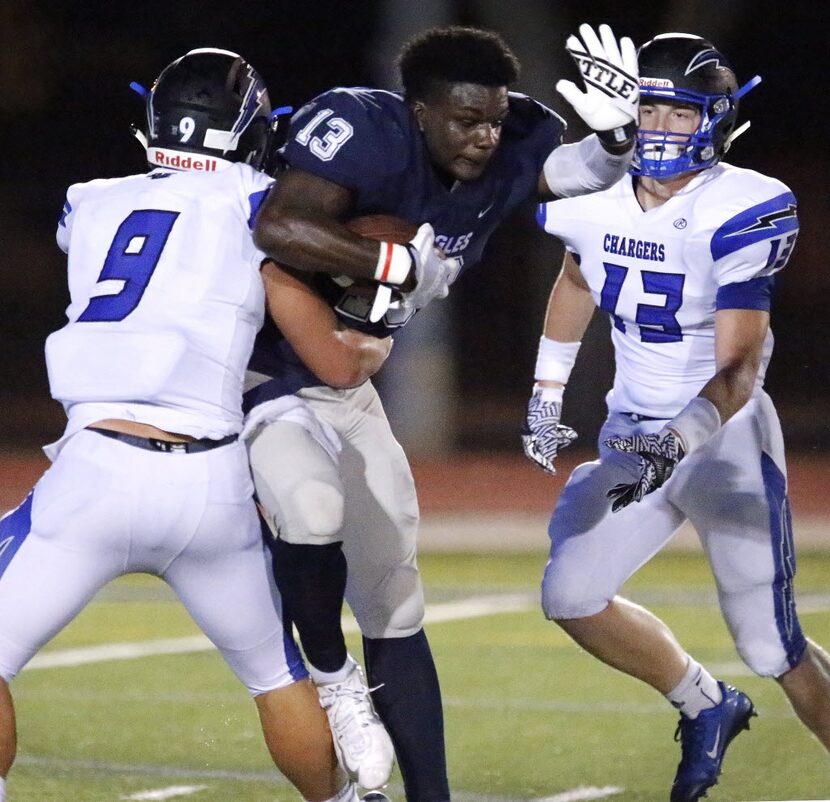 Episcopal School of Dallas running back Nakeie Montgomery (13) is tackled by Dallas Christan...