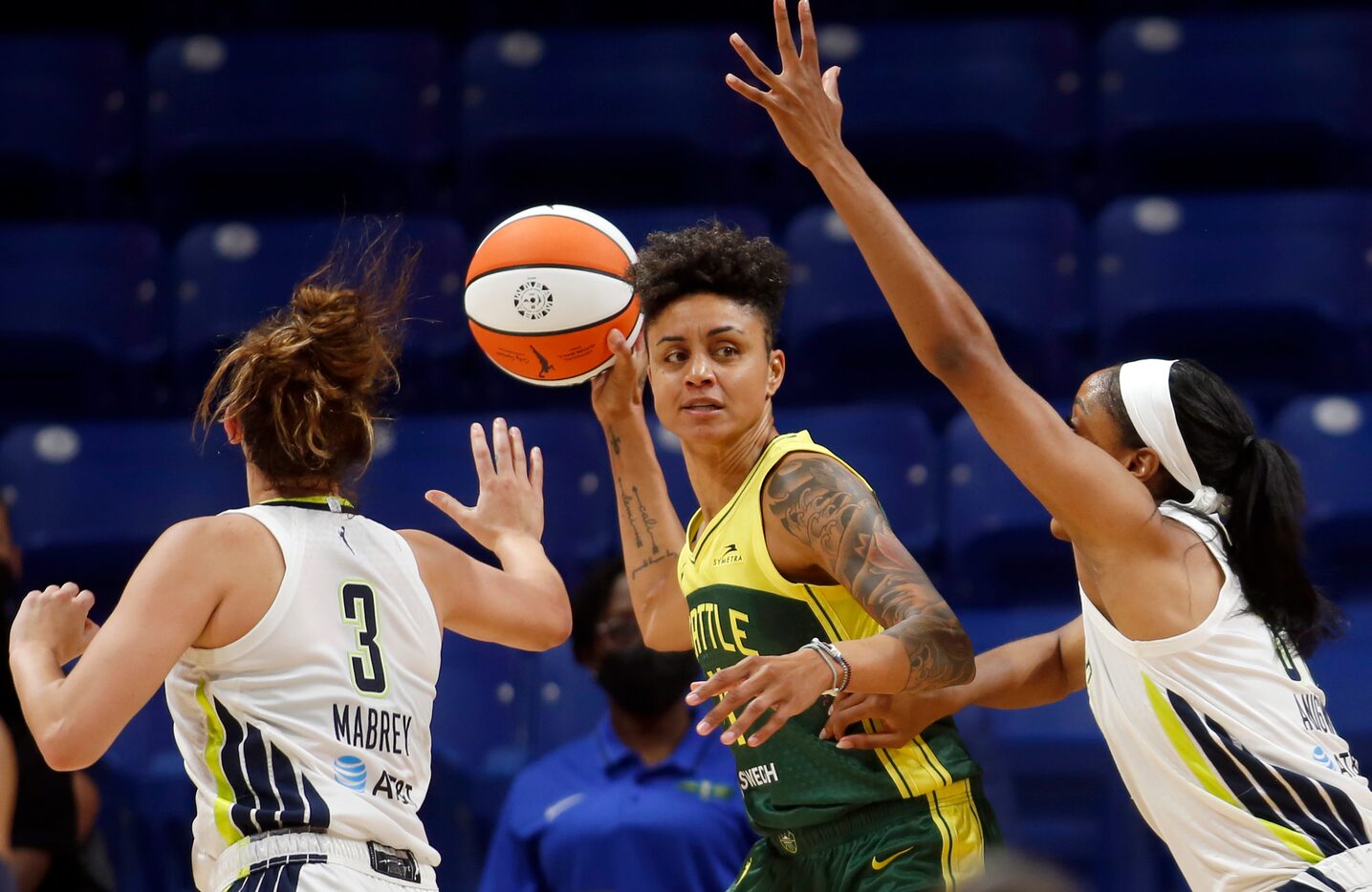 Seattle forward Candice Dupree (4) looks to pass as she faces the defense of Wings guard...