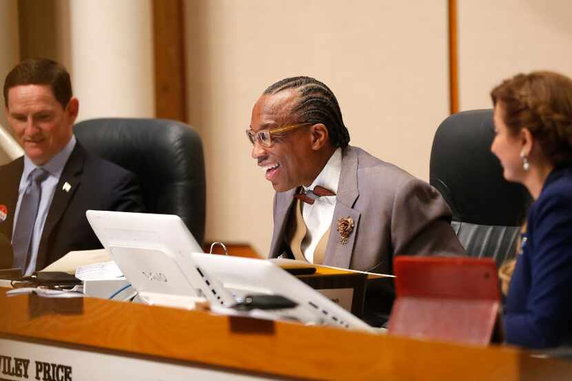 Dallas County Commissioner John Wiley Price smiles while speaking next to County Judge Clay...