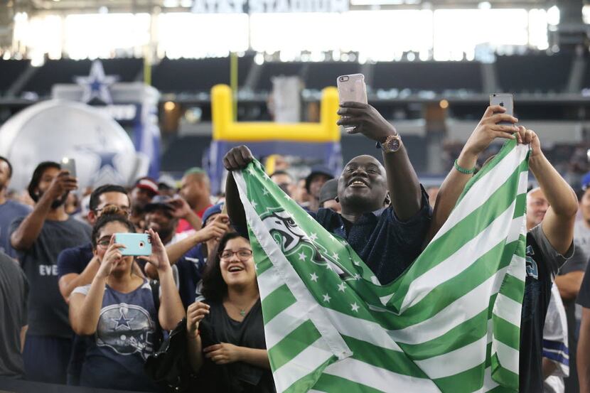Philadelphia Eagles fans Samea Sey (second from right) and Jose Pulido (covered with flag),...