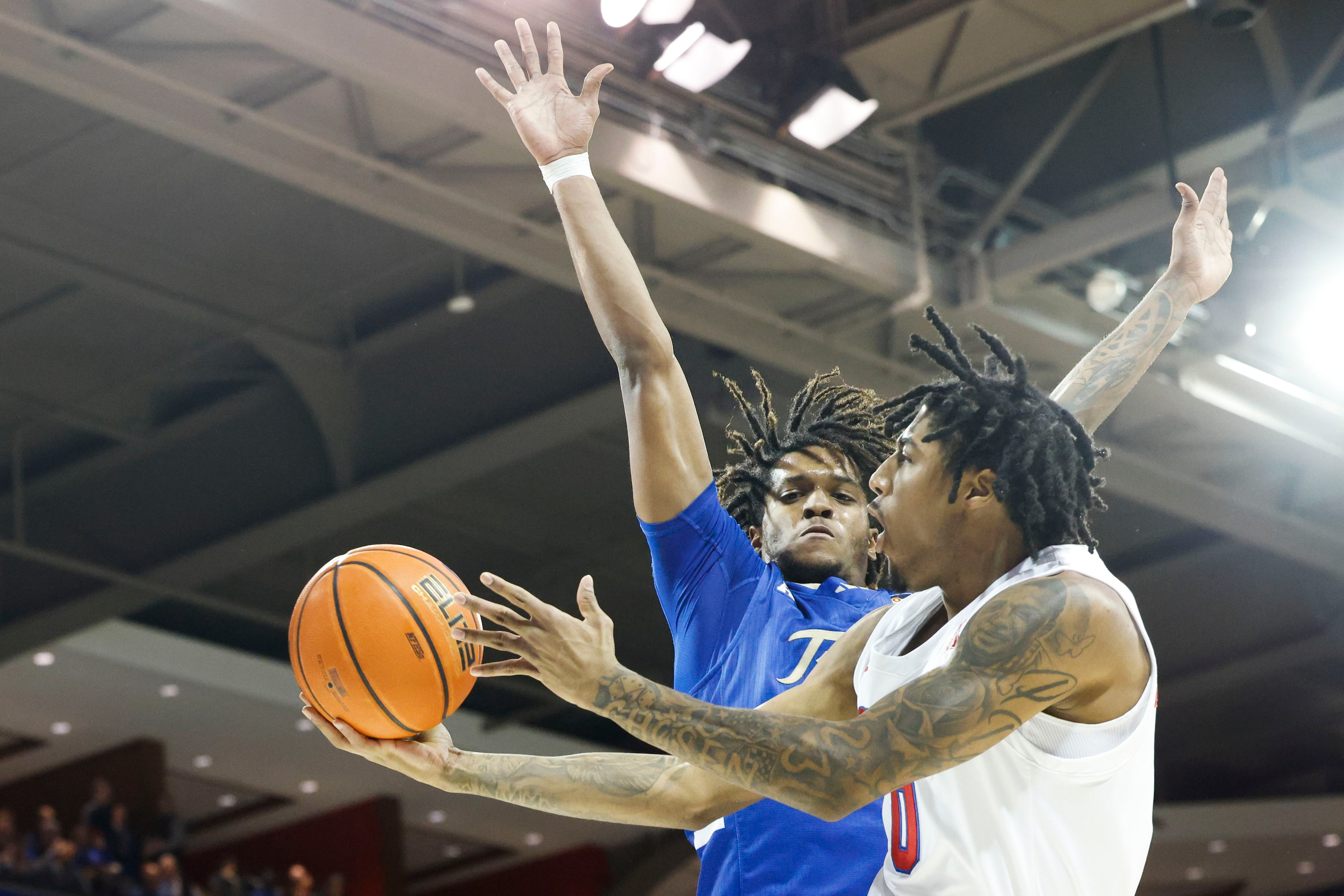 Tulsa guard Jesaiah McWright (back) fouls Southern Methodist guard B.J. Edwards during the...