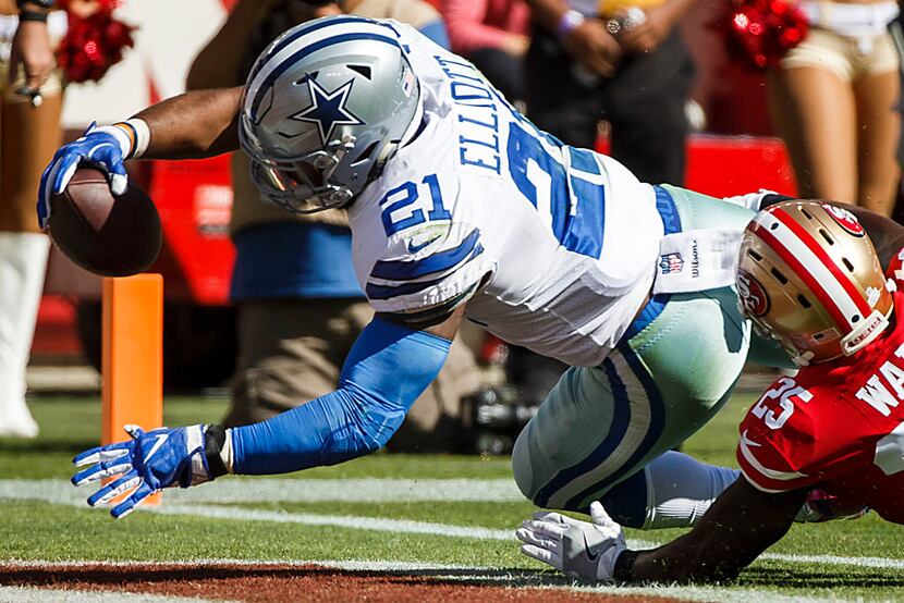Dallas Cowboys running back Ezekiel Elliott (21) dives past San Francisco 49ers free safety...