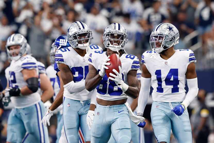 Dallas Cowboys wide receiver CeeDee Lamb (88) reacts after he got tripped up returning the...