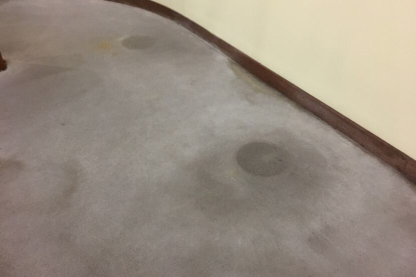 On the water-stained carpet at the Music Hall at Fair Park, a perfect circle where a white...