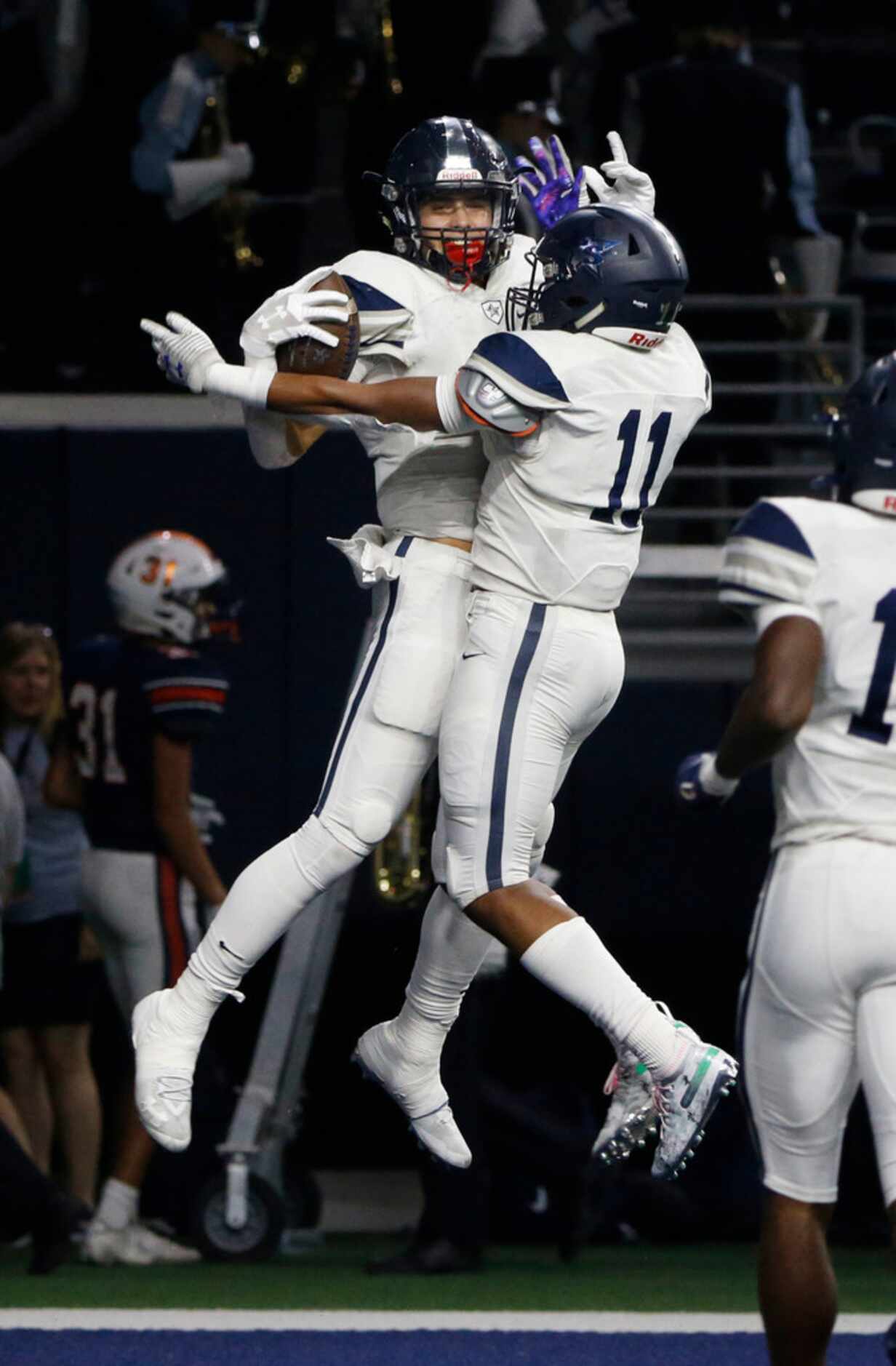 Frisco Lone Star's Trace Bruckler, left, celebrate his touchdown reception with teammate...