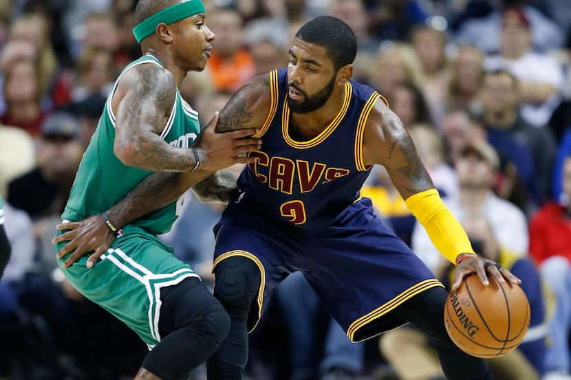 FILE - In this Nov. 3, 2016, file photo, Cleveland Cavaliers' Kyrie Irving, right, looks to...