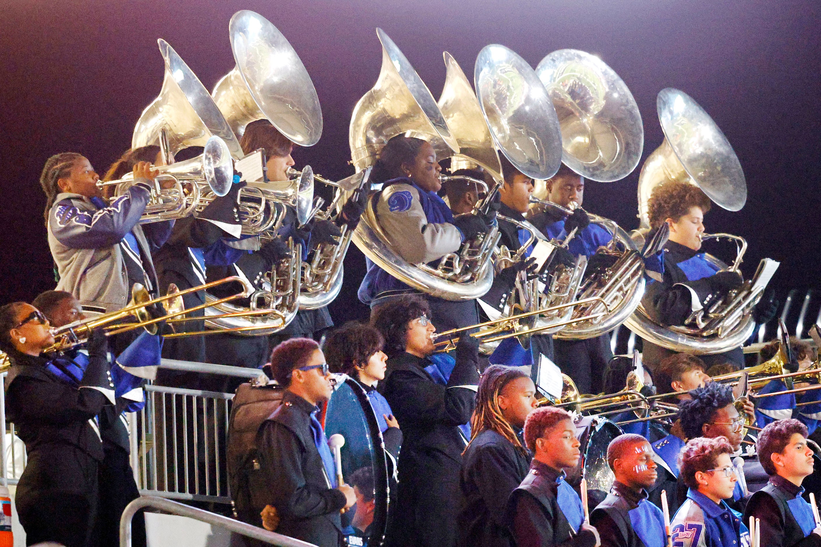 North Crowley marching band members perform before a high school football game against...