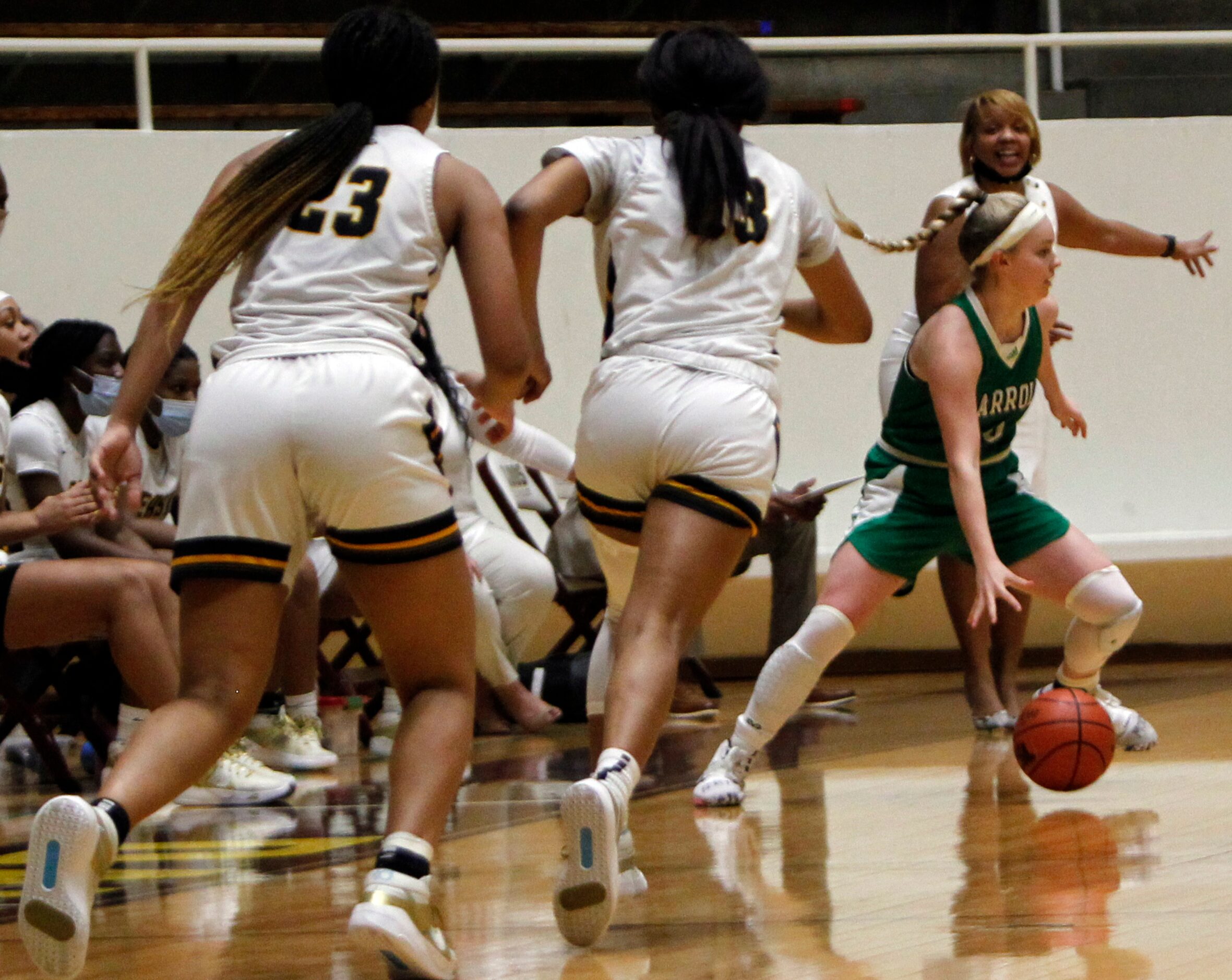 Southlake Carroll guard Brittney Flexer (4) pulls away from Plano East defenders as she...