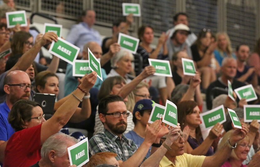 The crowd lets their feelings be known at a town hall meeting with Congressman Michael...