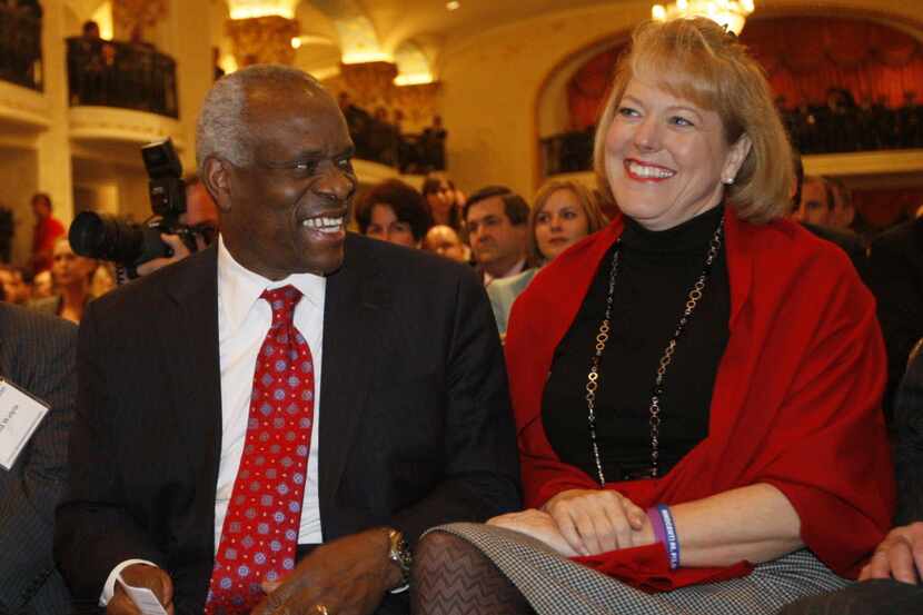 FILE - In this Nov. 15, 2007 file photo, Supreme Court Justice Clarence Thomas sits with his...