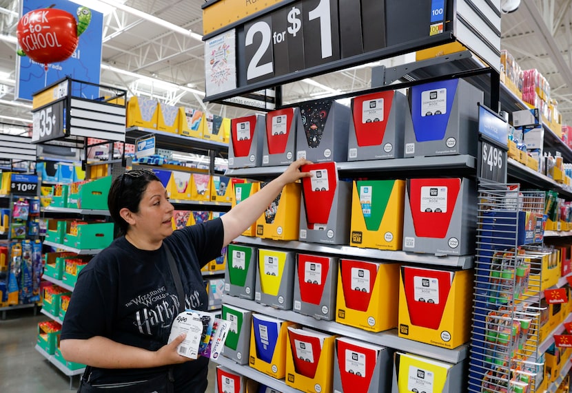 DISD 4th grade teacher Diana Topel reaches for a notebook while shopping for supplies for...