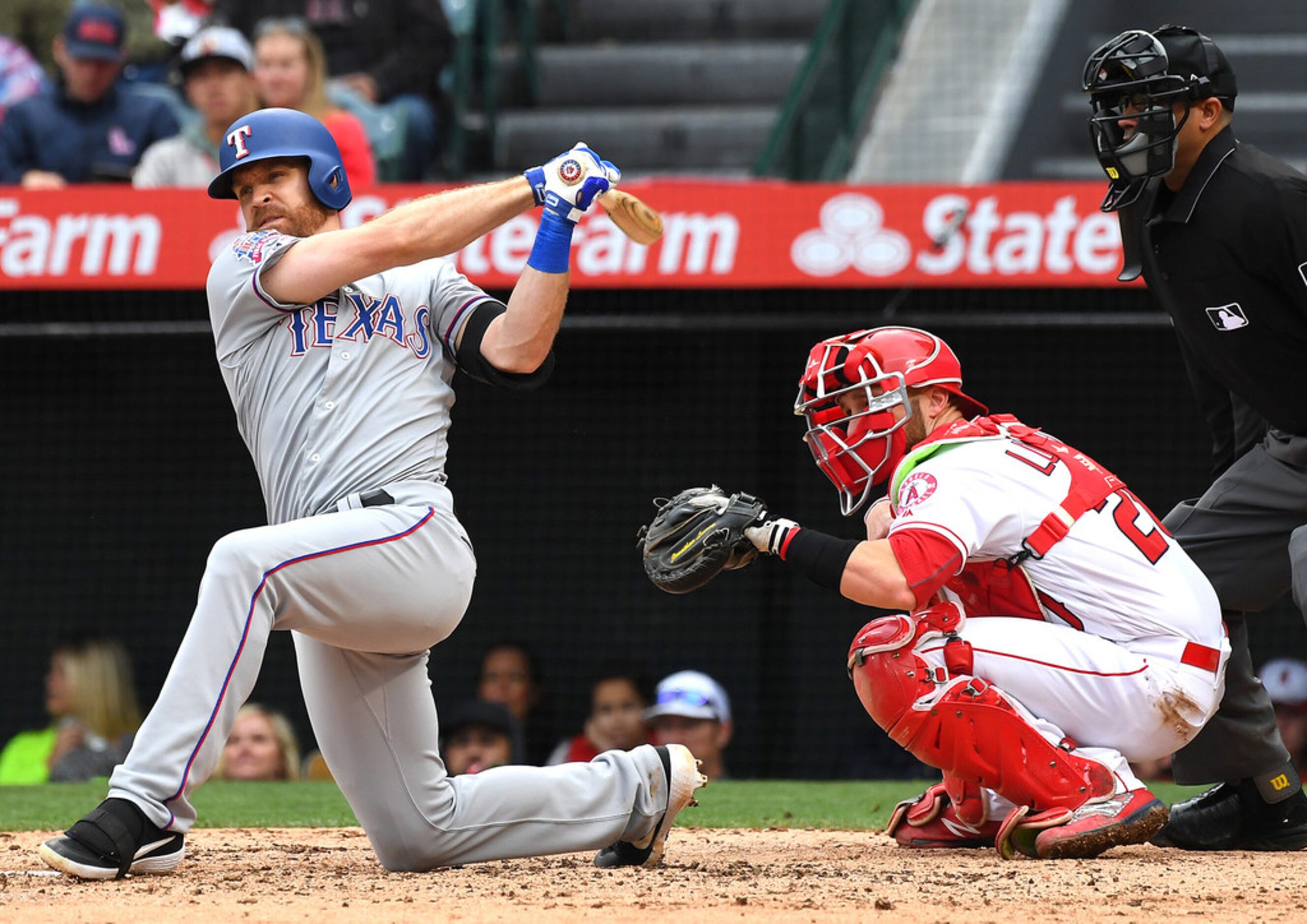 Jonathan Lucroy (20) of the Los Angeles Angels of Anaheim crouches behind the plate as Logan...