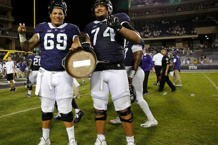 TCU Horned Frogs offensive tackle Aviante Collins (69) and TCU Horned Frogs offensive tackle...