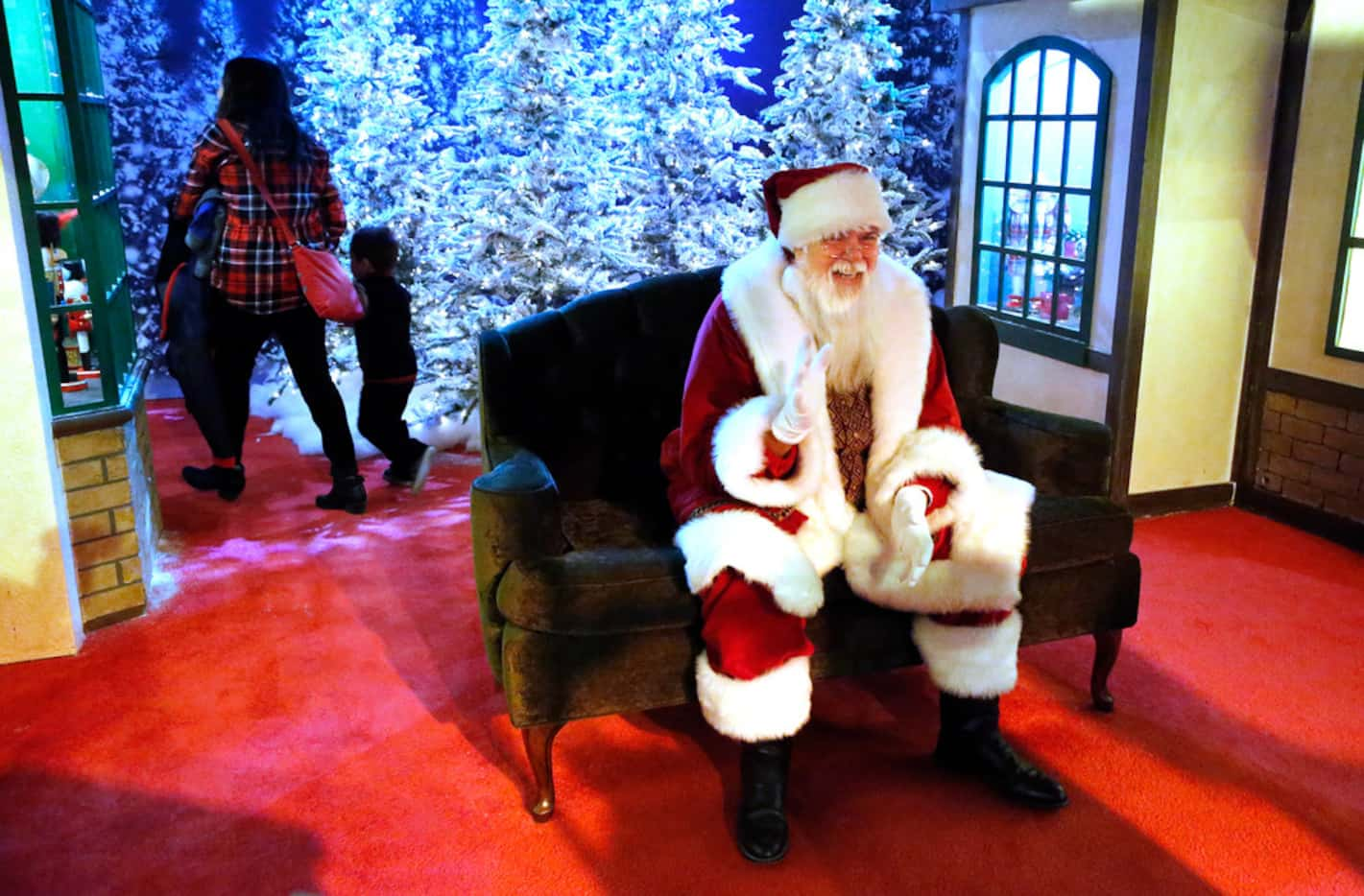 Santa is jolly after a visit with Jacob Eick, 3, of Dallas and his mother Maria Elena Eick...