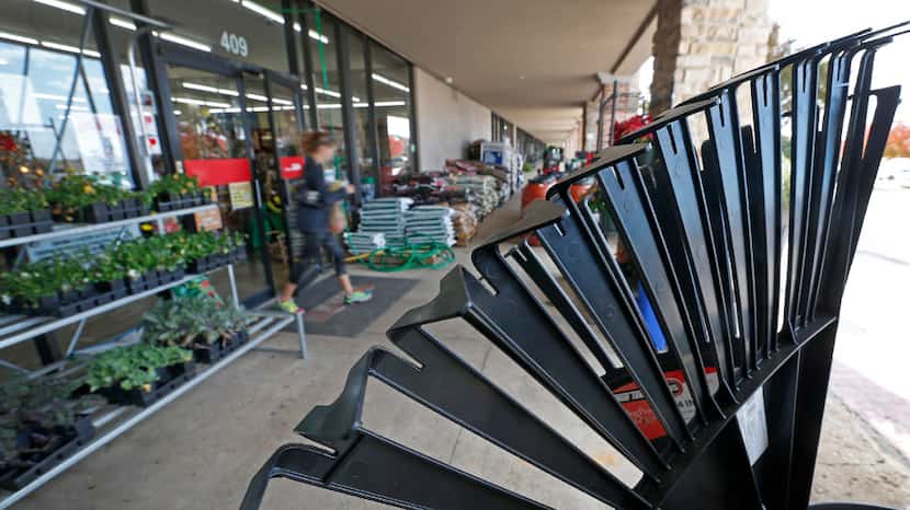 Customer Jane Griffin walks out of the new Rooster Home & Hardware store after shopping for...