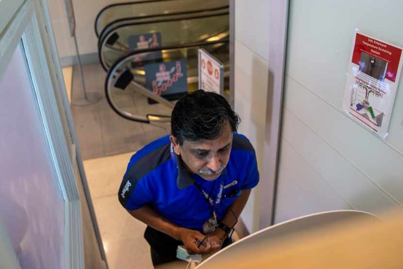 Southwest Airlines customer service supervisor Arshad Khan goes through a temperature check...