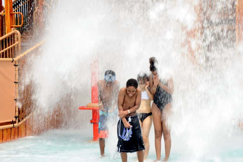 The giant bucket tips over and splashes water park guests at Paradise Springs at Gaylord...
