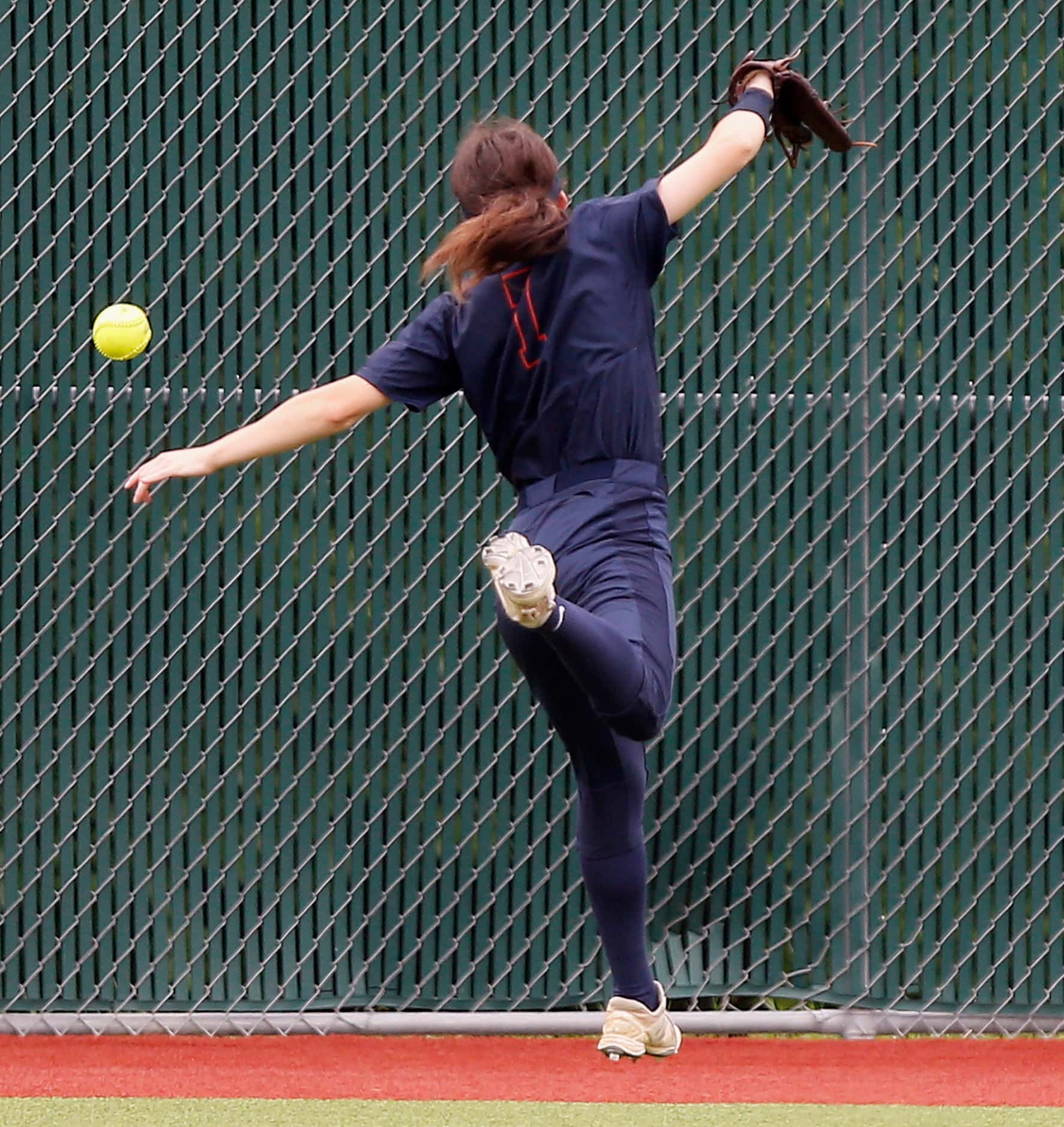 Wakeland left fielder Jaina Head (7) was unable to make the play on a ball hit over her head...