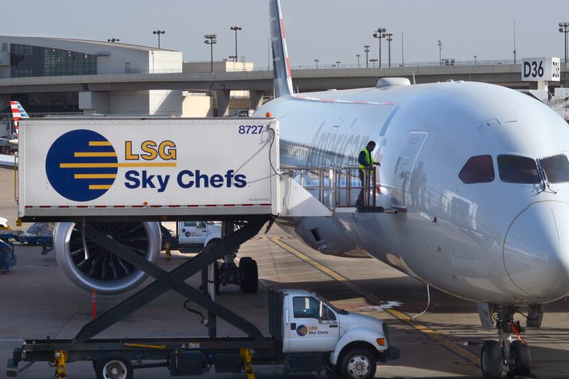 An employee of LSG Sky Chefs prepares to load food and drinks onto an American Airlines...