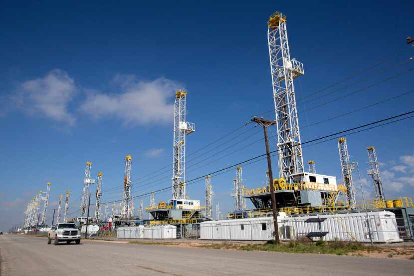 FILE - In this May 18, 2015, file photo, more than 30 oil drilling rigs stood idle in...
