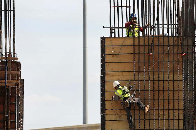 
A construction worker braces himself on a job site in Houston, a hub of the energy...