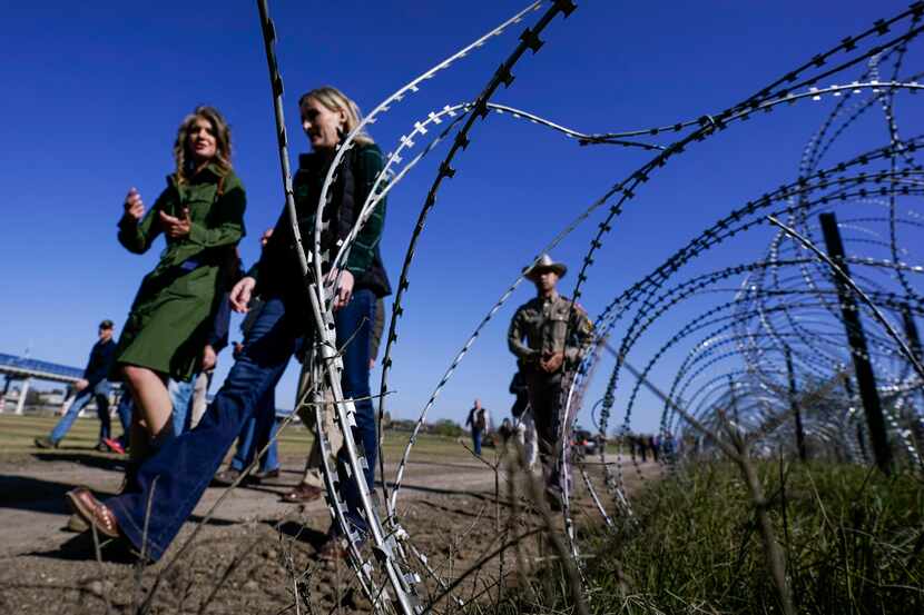 Concertina wire is seen as Republican members of Congress tour the Texas-Mexico border,...