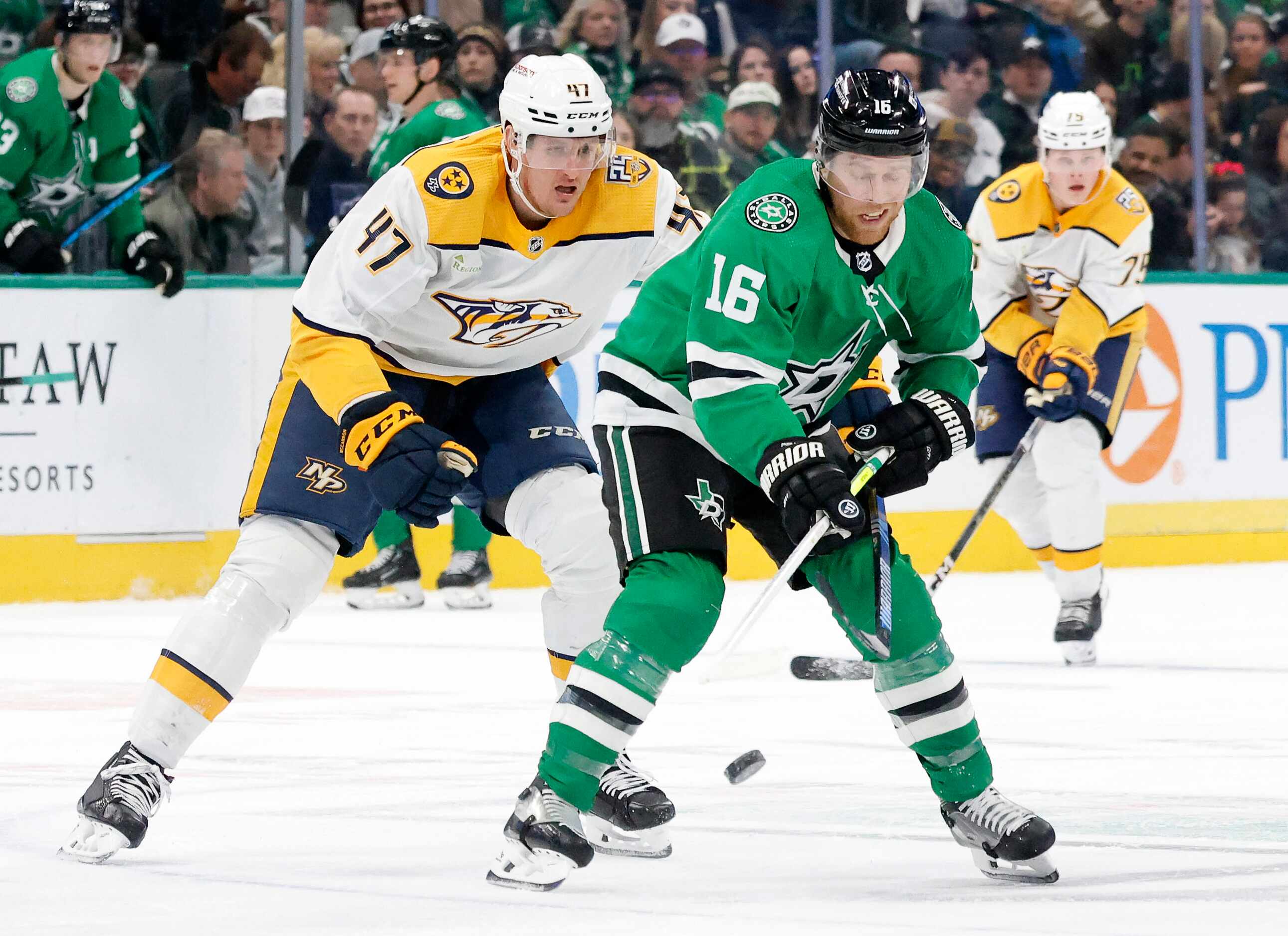 Dallas Stars center Joe Pavelski (16) tries to get a stick on the puck as he is pursued by...