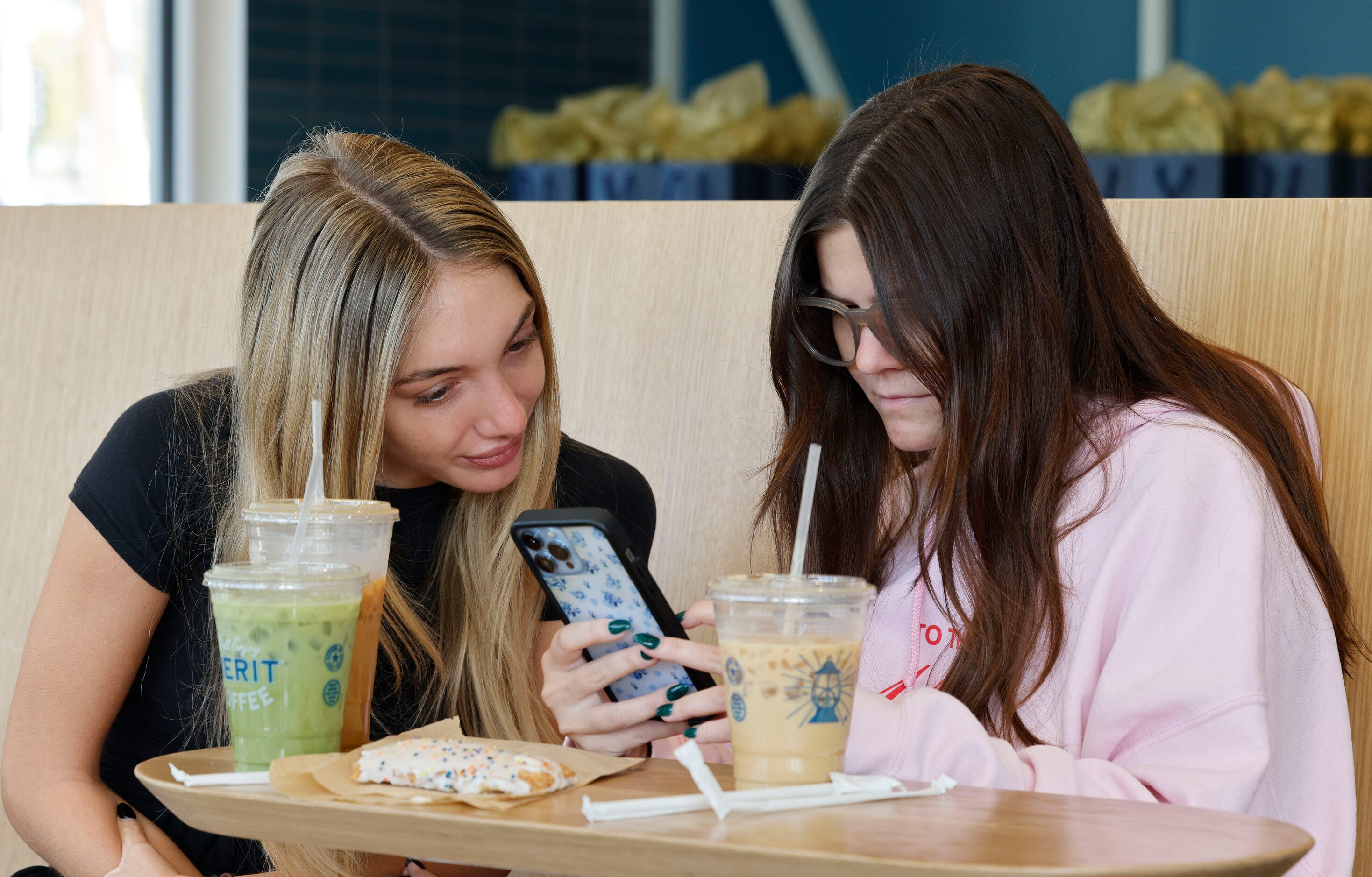 Caroline Bell, left, and her friend Annie Shimek, both from Dallas, attend a soft opening of...