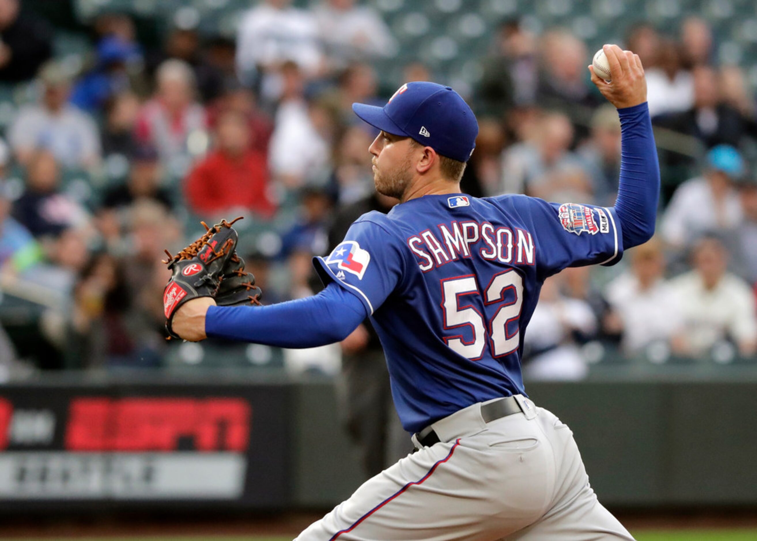 Texas Rangers starting pitcher Adrian Sampson throws during the second inning of a baseball...