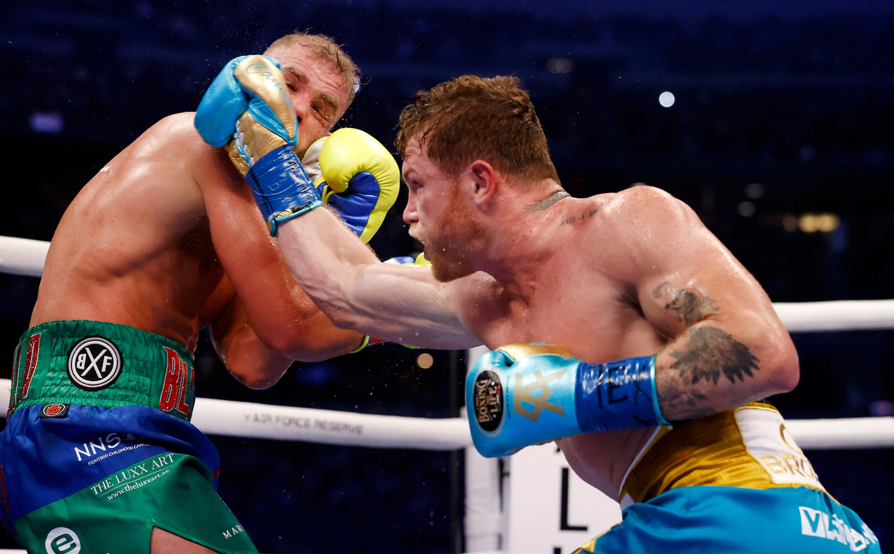 Boxer Canelo Alvarez (right) lands a punch on Billy Joe Saunders during their super...