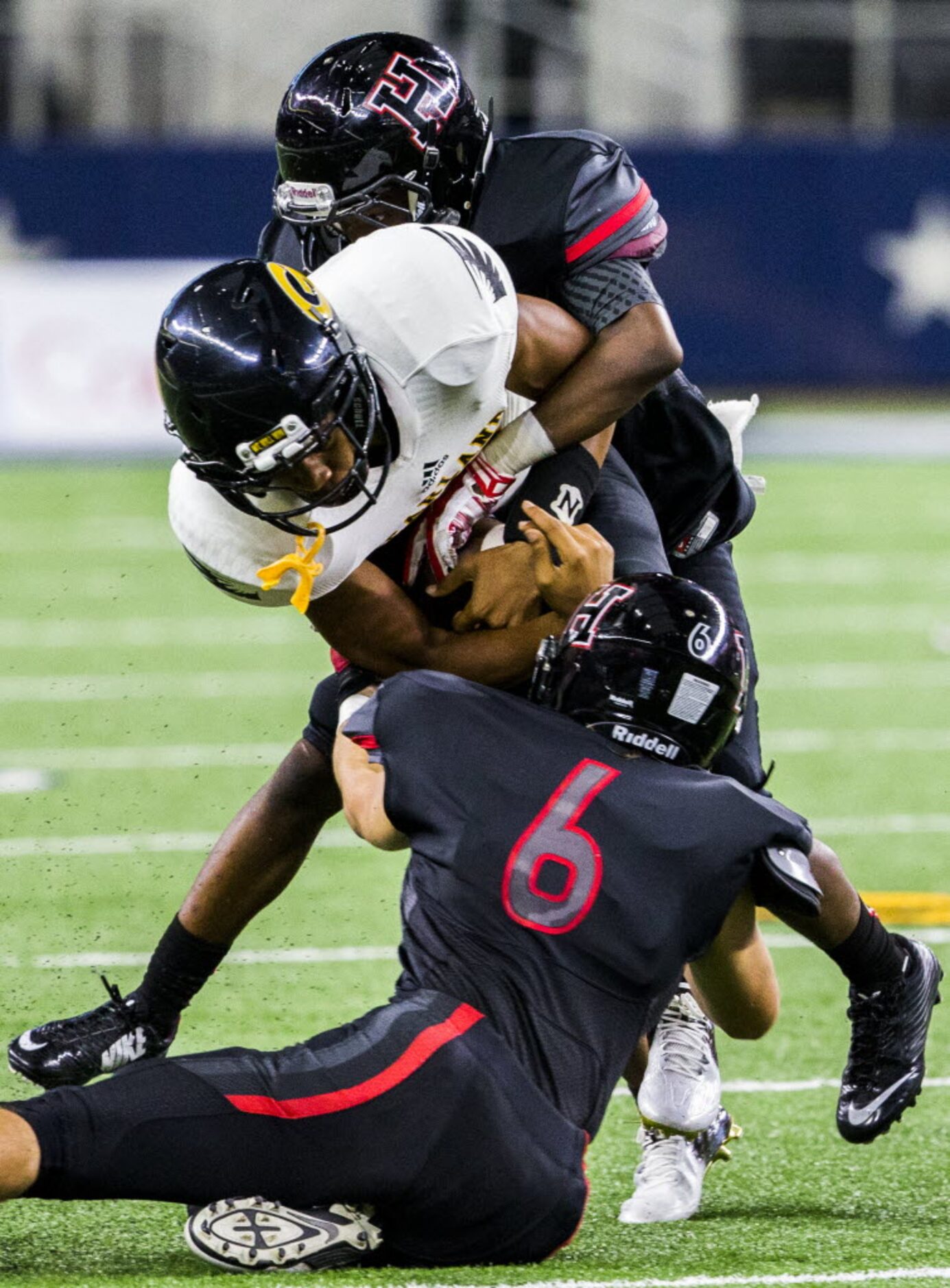 Garland wide receiver Coree Compton (11) is tackled by Rockwall-Heath's Tyrus Fort (5) and...