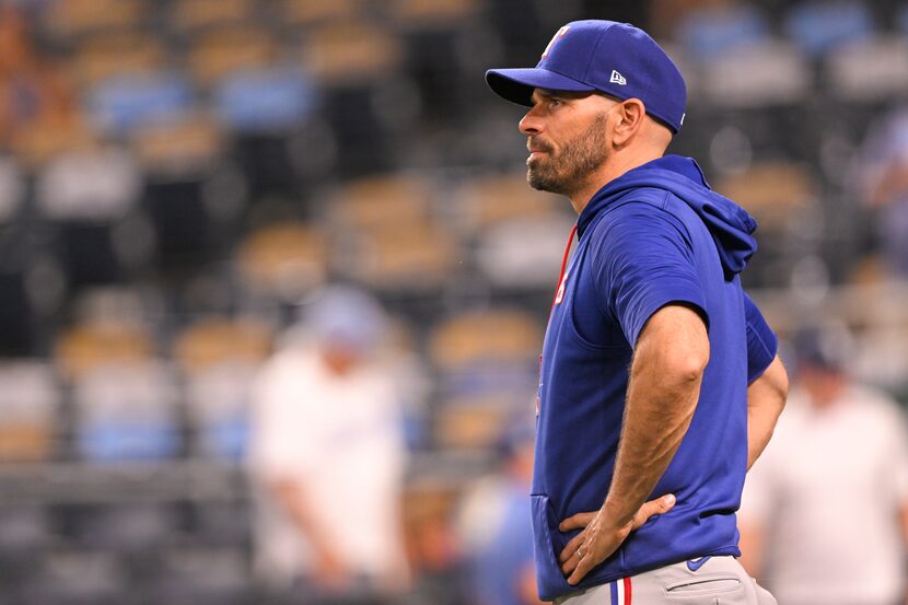 Texas Rangers manager Chris Woodward waits for players to come off the field after a win...