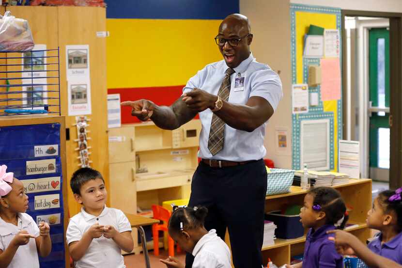 Former Dallas Cowboys player DeMarcus Ware, principal for a day, participates in a morning...