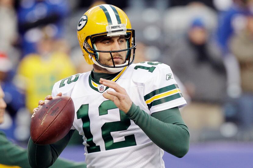 Green Bay Packers' Aaron Rodgers warms up before an NFL football game against the New York...