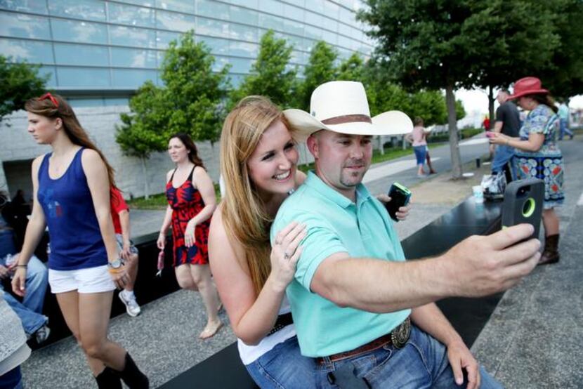 
George Strait fans Kourtney Rae Dickerson of Stephenville, Texas, and Dusty Trimuar of...