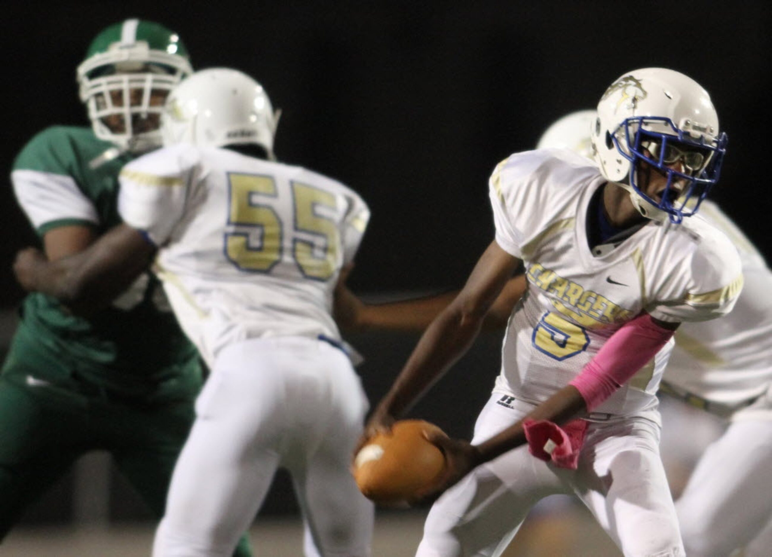 Conrad quarterback Stan Fair (5) pitches to his running back during second quarter action...