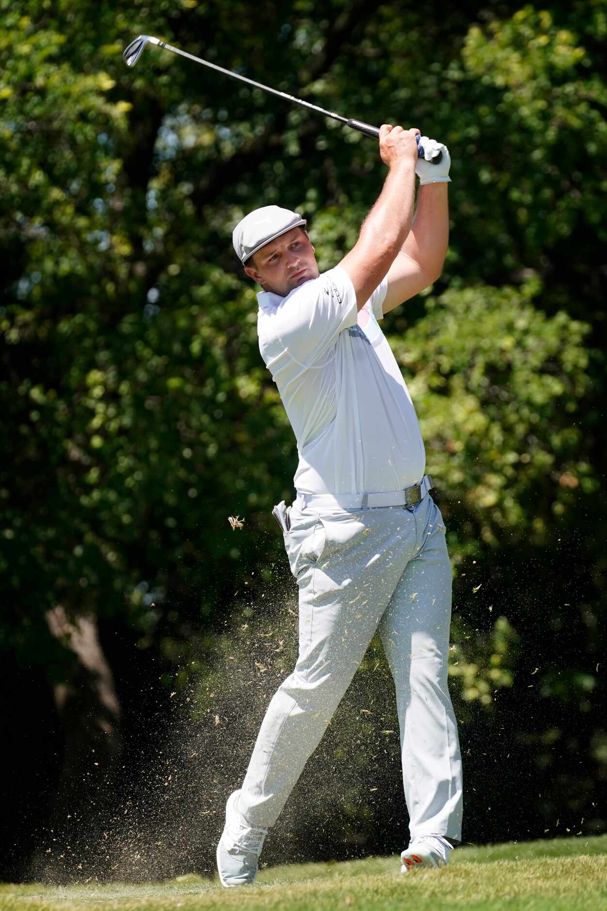 PGA Tour golfer Bryson DeChambeau follows through on his iron shot on the No. 9 tee during...