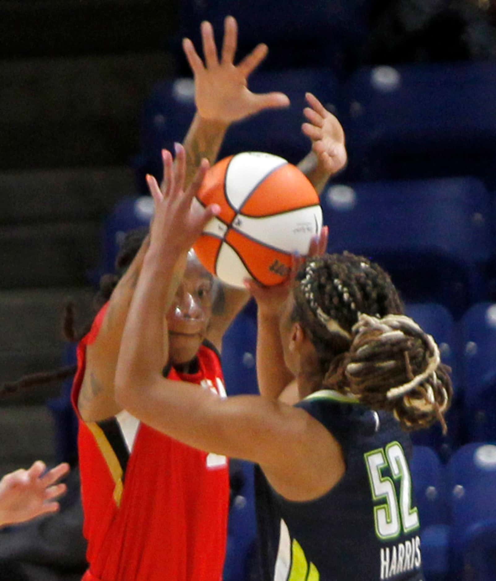 Dallas Wings guard Tyasha Harris (52) shoots as she is defended by Las Vegas guard Riquana...