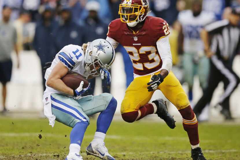 Dallas Cowboys wide receiver Cole Beasley (11) is tackled by Washington Redskins cornerback...