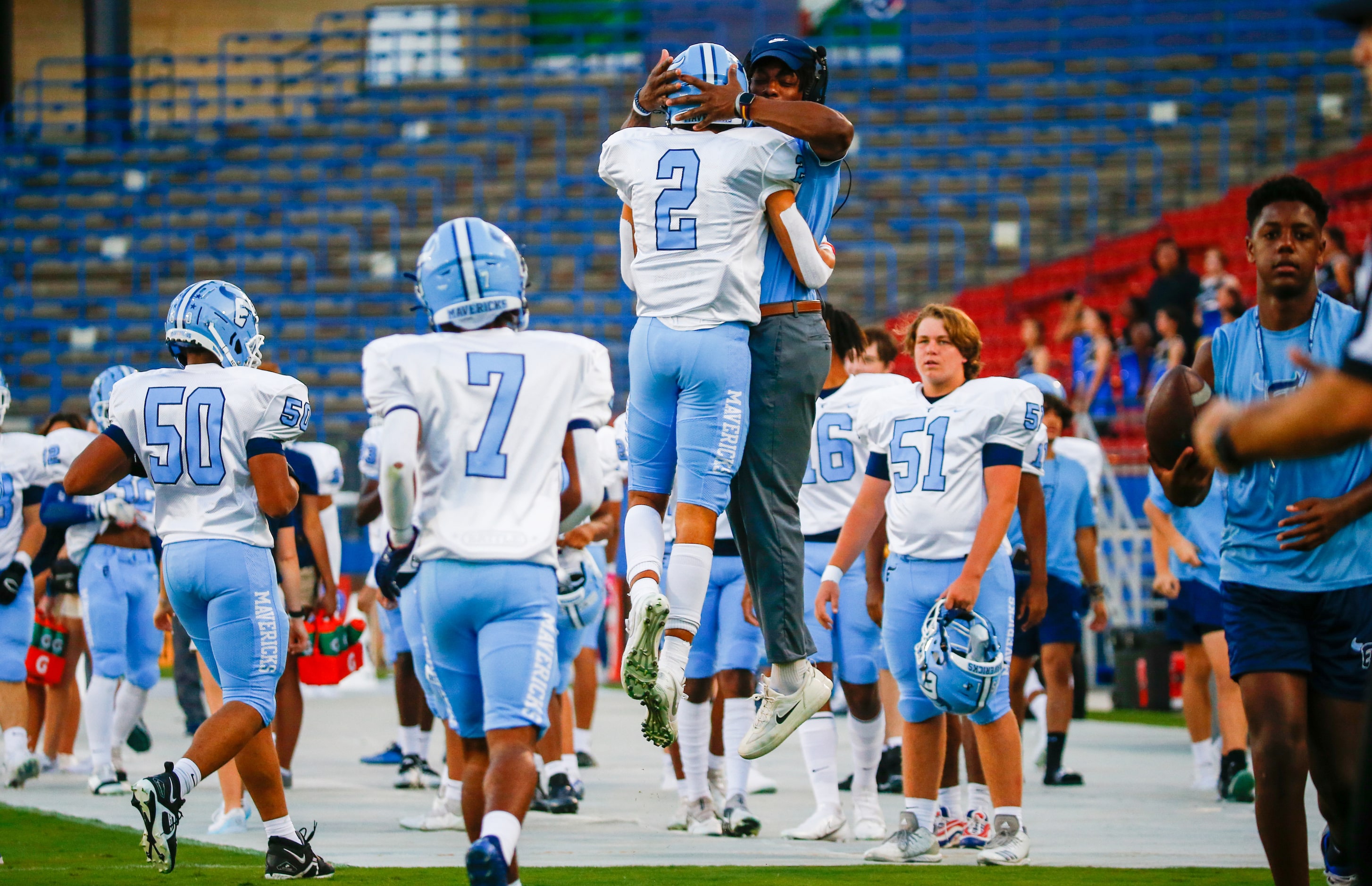 Emerson Mavericks wide receiver Kylen Evans (2) celebrates a touchdown with a coach during...