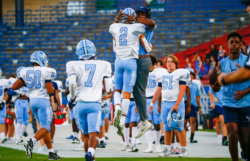 Emerson Mavericks wide receiver Kylen Evans (2) celebrates a touchdown with a coach during...