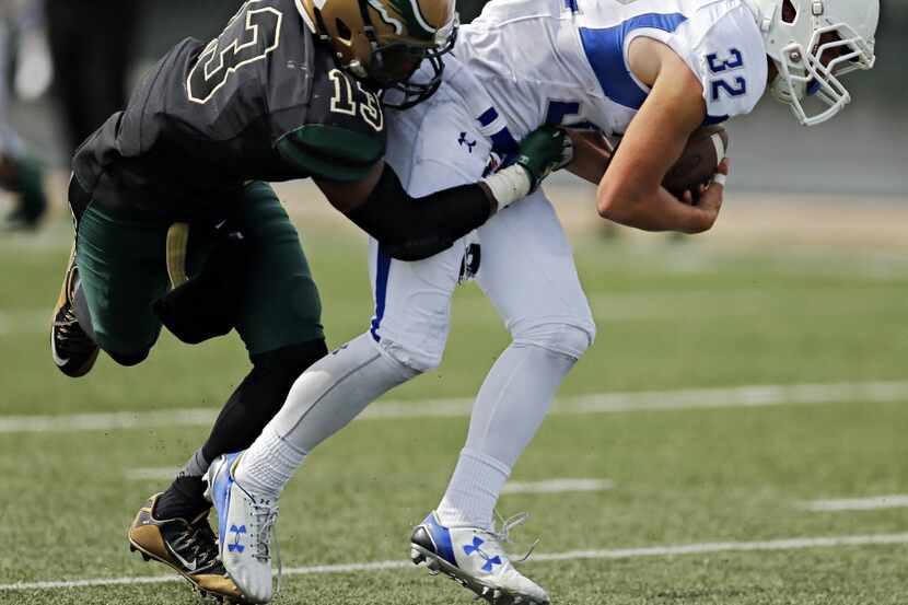 DeSoto's Isaiah Stewart (13) stops a run by IMG's Khalil Ladler during the second half of...